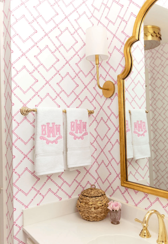 Pink wallpaper monogram towels bathroom